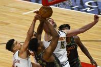 Chicago Bulls center Wendell Carter Jr., center, fights for the ball with Denver Nuggets forward Michael Porter Jr., left, forward Will Barton, back, and center Nikola Jokic, (15), during the first half of an NBA basketball game Monday, March 1, 2021, in Chicago. (AP Photo/Matt Marton)