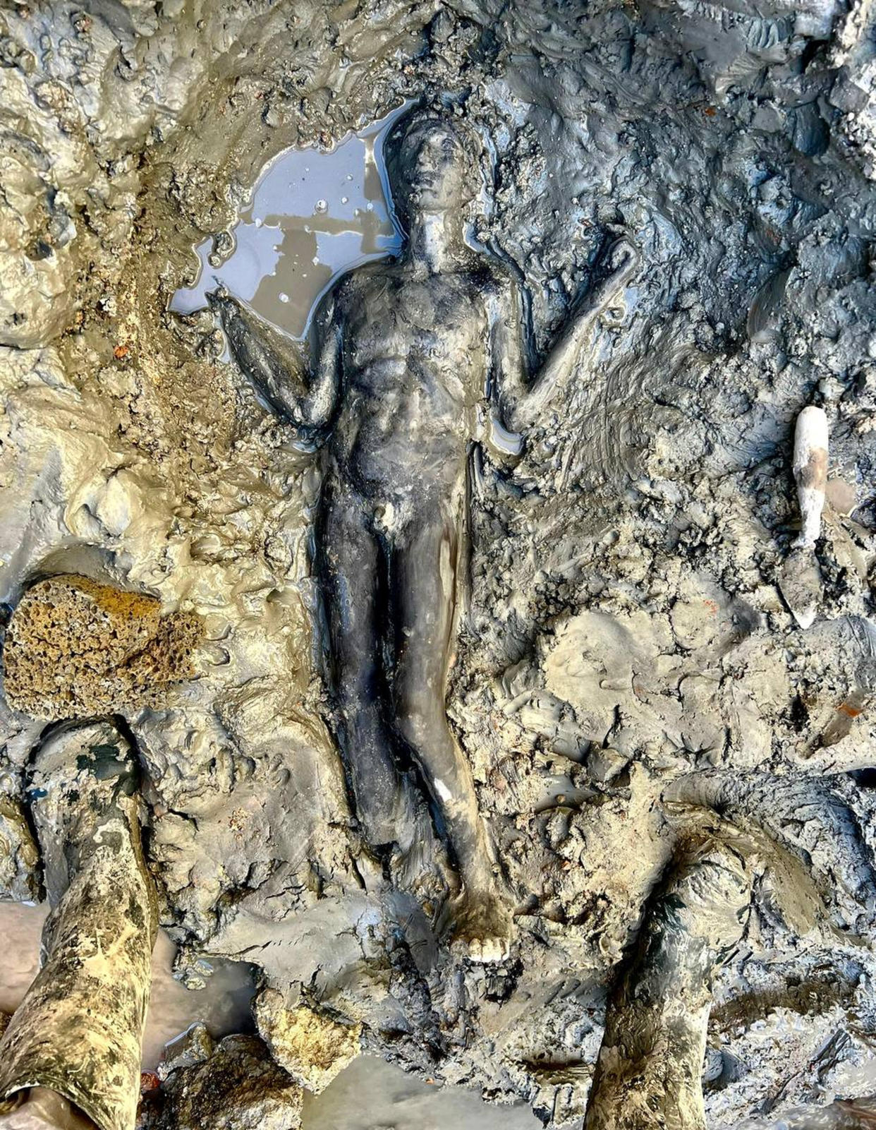 A statue is seen at the site of the discovery of two dozen well-preserved bronze statues from an ancient Tuscan thermal spring in San Casciano dei Bagni, central Italy, in this undated photo made available by the Italian Culture Ministry, Thursday, Nov. 3, 2022. (Italian Culture Ministry via AP)