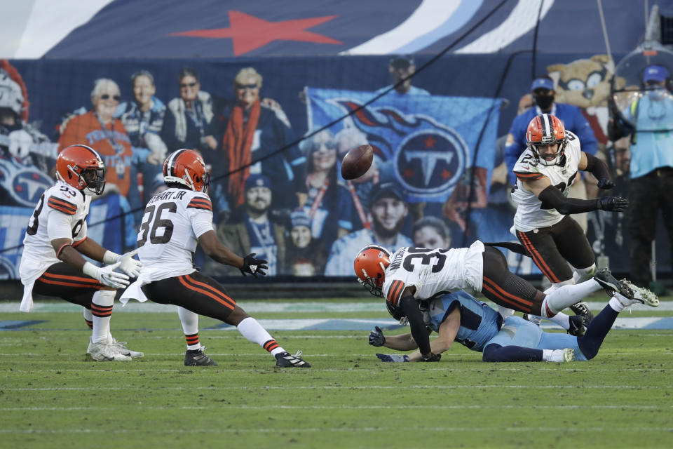 Cleveland Browns cornerback M.J. Stewart (36) intercepts a pass after cornerback Terrance Mitchell (39) knocked it out of the hands of Tennessee Titans wide receiver Adam Humphries, on the ground, in the second half of an NFL football game Sunday, Dec. 6, 2020, in Nashville, Tenn. (AP Photo/Ben Margot)