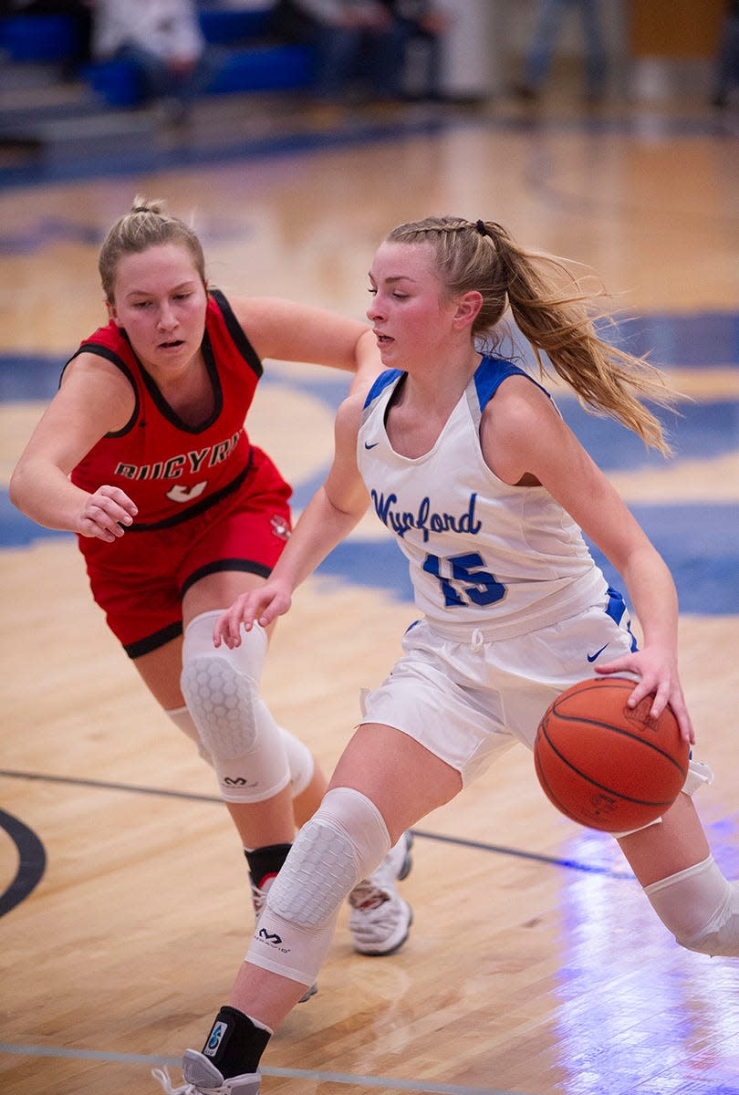 Wynford's Grace Stucky drives into the paint with Bucyrus' Madalyn Kimmel closing in.