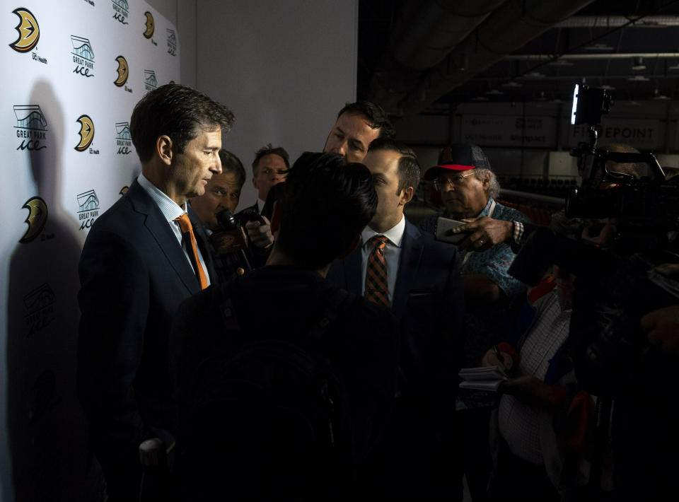 New Anaheim Ducks head coach Dallas Eakins, left, talks to the media following an NHL hockey news conference in Irvine, Calif., Monday, June 17, 2019. (Paul Bersebach/The Orange County Register via AP)