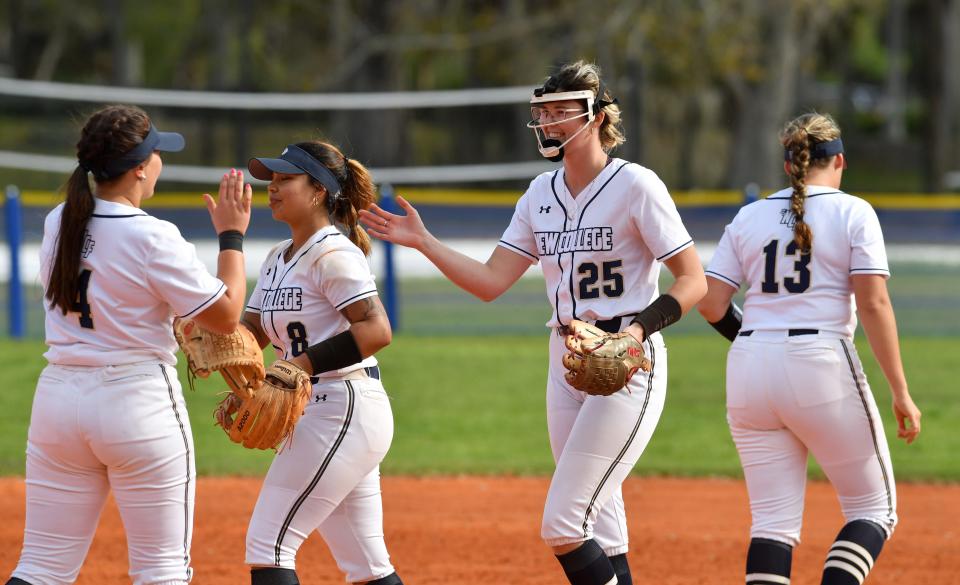 New College of Florida softball players, from left, Madilyn Dutton (#4), Jalyssa Ledesma (#8), Jayleigh Totten (#25), and Cheyenne Waddel (#13) congratulate each other after forcing a runner out. The New College Mighty Banyans softball team hosted St. Thomas University in a double-header Tuesday, Feb. 13, 2024.