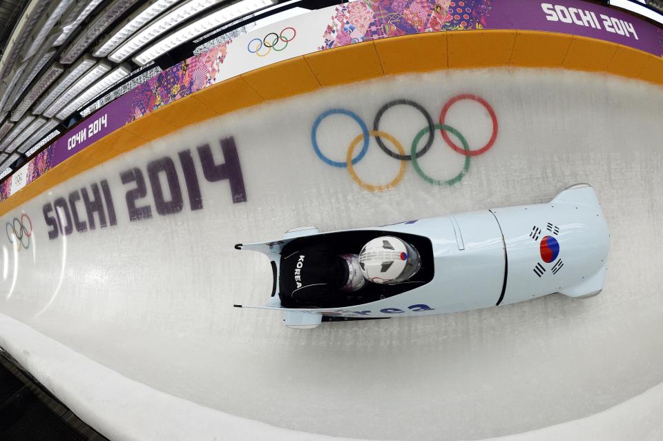 South Korea's two-woman bobsleigh steered by Kim Sunok takes a practice run during a training session at the Sanki Sliding Center in Rosa Khutor during the Sochi Winter Olympics on February 16, 2014.