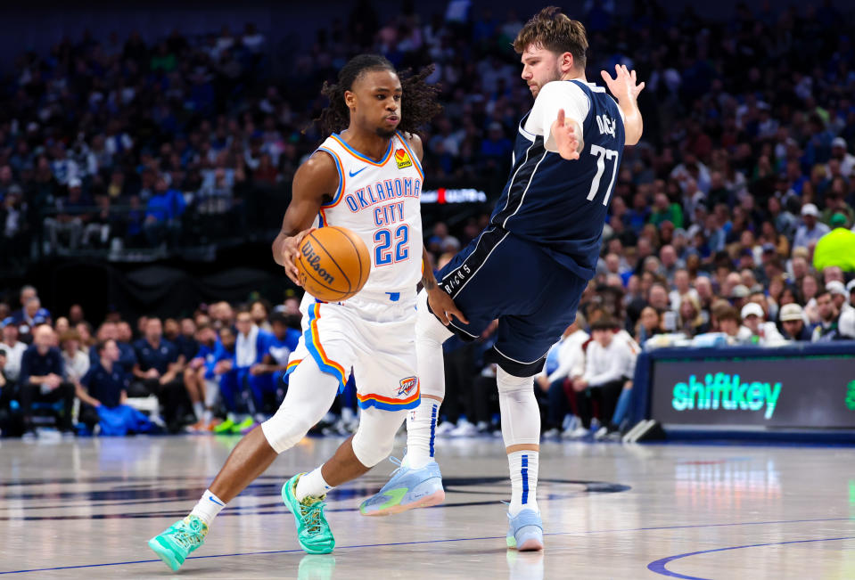 Feb 10, 2024; Dallas, Texas, USA; Oklahoma City Thunder guard <a class="link " href="https://sports.yahoo.com/nba/players/10107/" data-i13n="sec:content-canvas;subsec:anchor_text;elm:context_link" data-ylk="slk:Cason Wallace;sec:content-canvas;subsec:anchor_text;elm:context_link;itc:0">Cason Wallace</a> (22) dribbles as Dallas Mavericks guard Luka Doncic (77) defends during the first half at American Airlines Center. Mandatory Credit: Kevin Jairaj-USA TODAY Sports