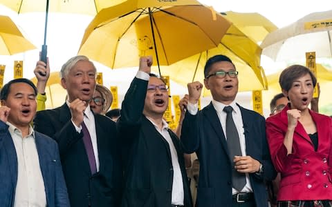 Pro-democracy activists Lee Wing-tat, Chu Yiu-ming, Benny Tai, Chan Kin-man, Tanya Chan pose for a photograph during a rally outside West Kowloon Court on November 19 - Credit:  Anthony Kwan/ Getty Images AsiaPac