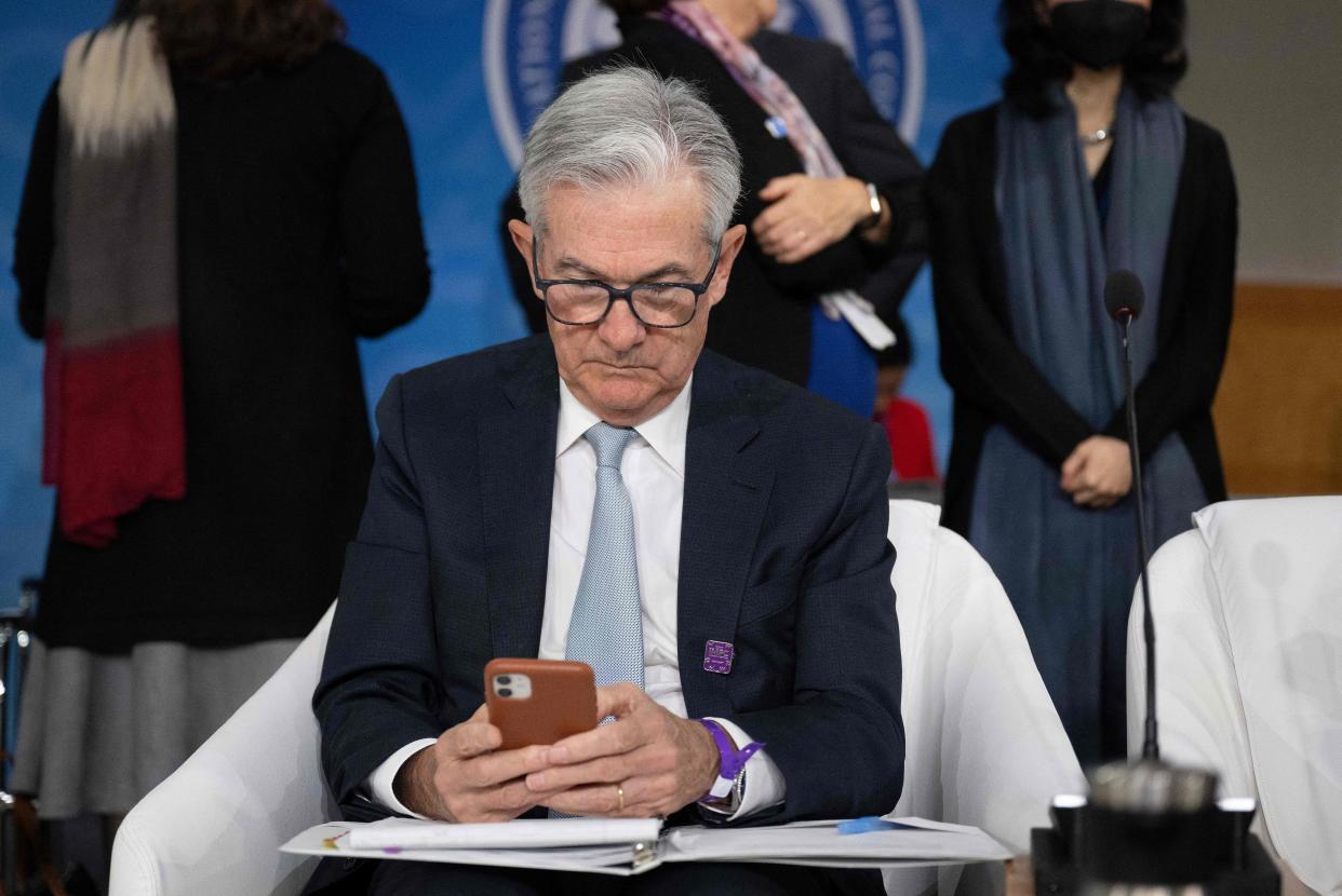 Federal Reserve Chair Jerome Powell looks at his phone during a meeting of the International Monetary and Financial Committee at the International Monetary Fund World Bank Group Annual Meetings in Washington, DC, on October 14, 2022. (Photo by Jim WATSON / AFP) (Photo by JIM WATSON/AFP via Getty Images)