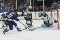 St. Louis Blues' Tyler Bozak (21) scores a goal against Minnesota Wild's Mats Zuccarello (36) and goalie Cam Talbot (33) during the second period in Game 6 of an NHL hockey Stanley Cup first-round playoff series Thursday, May 12, 2022, in St. Louis. (AP Photo/Michael Thomas)