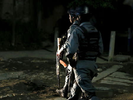 Afghan policemen keep watch at the site of an attack in Kabul May 14, 2015. REUTERS/Omar Sobhani