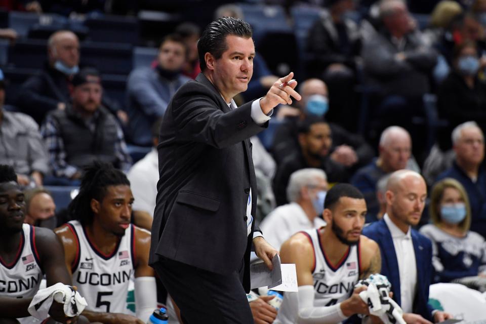 Connecticut assistant coach Tom Moore gestures during a game in 2021.