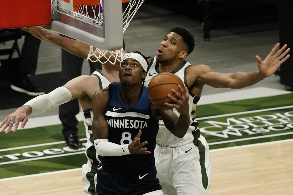 Minnesota Timberwolves' Jarred Vanderbilt shoots past Milwaukee Bucks' Giannis Antetokounmpo during the first half of an NBA basketball game Tuesday, Feb. 23, 2021, in Milwaukee. (AP Photo/Morry Gash)