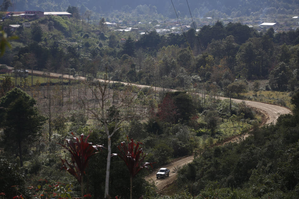 A truck drives past on a dirt road in Yalambojoch, Guatemala, Saturday, Dec. 29, 2018. There are no jobs in Yalambojoch, and people live off local commerce and meager subsistence farming. Locals say the Guatemalan government has turned a blind eye to their plight, a complaint that can be heard in similarly impoverished villages elsewhere in the country. (AP Photo/Moises Castillo)