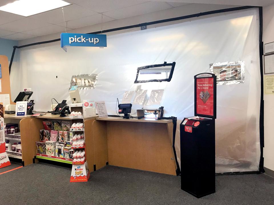 The pharmacy at a local CVS wrapped in plastic March 26, 2020.