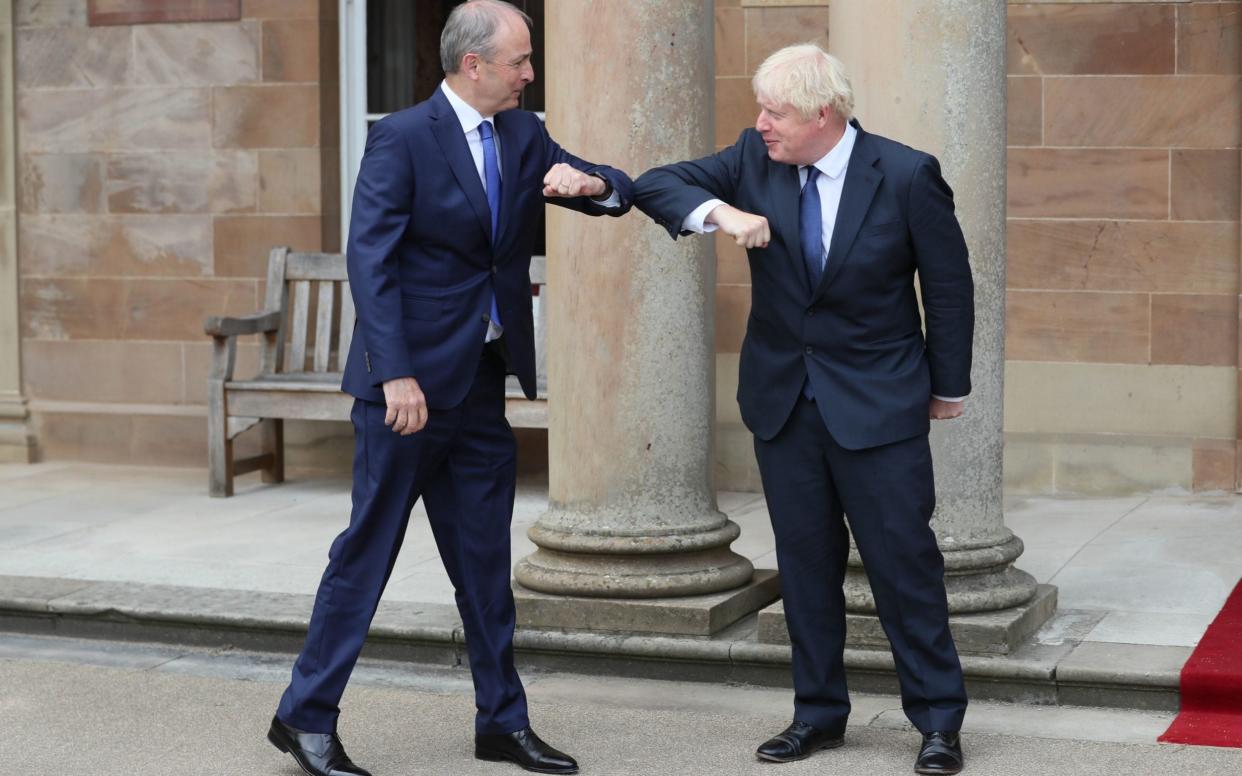 Prime Minister Boris Johnson (right) and Taoiseach Micheal Martin greet each other with an elbow bump at Hillsborough Castle during the Prime Minister's visit to Belfast in August. - PA