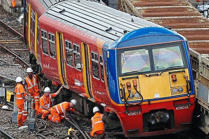 Off the rails: engineers attend to the train that derailed outside Waterloo on Tuesday
