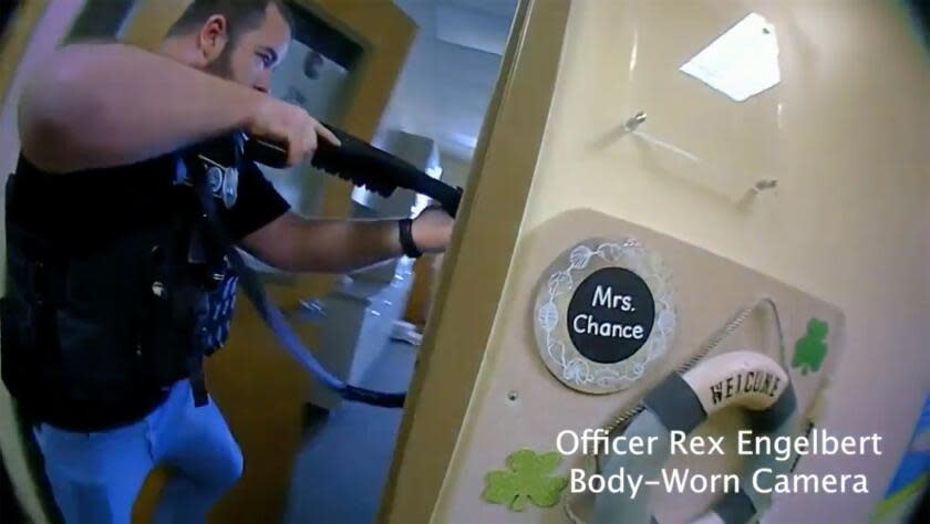 This image provided by Metropolitan Nashville Police Department shows bodycam footage of police responding to an active shooting at The Covenant School in Nashville, Tenn., on Monday, March 27, 2023. The former student who shot through the doors of the Christian elementary school and killed three children and three adults had drawn a detailed map of the school. (Metropolitan Nashville Police Department via AP)