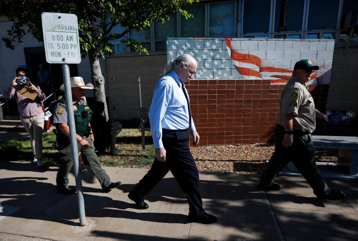 James Phelps is escorted by two Dallas County Sheriff's deputies as he leaves the Dallas County Courthouse after waiving his right to a preliminary hearing on Thursday, July 14, 2022. 