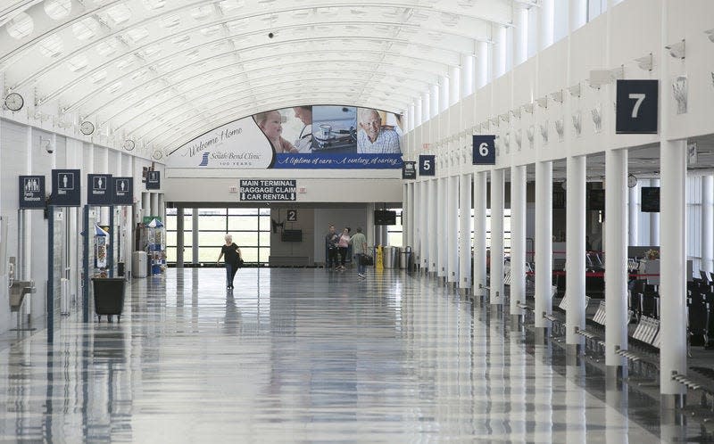 Travelers walk through the South Bend International Airport. When the pandemic hit and travel plummeted, operations staff at the airport kept working. Tribune Photo/SANTIAGO FLORES