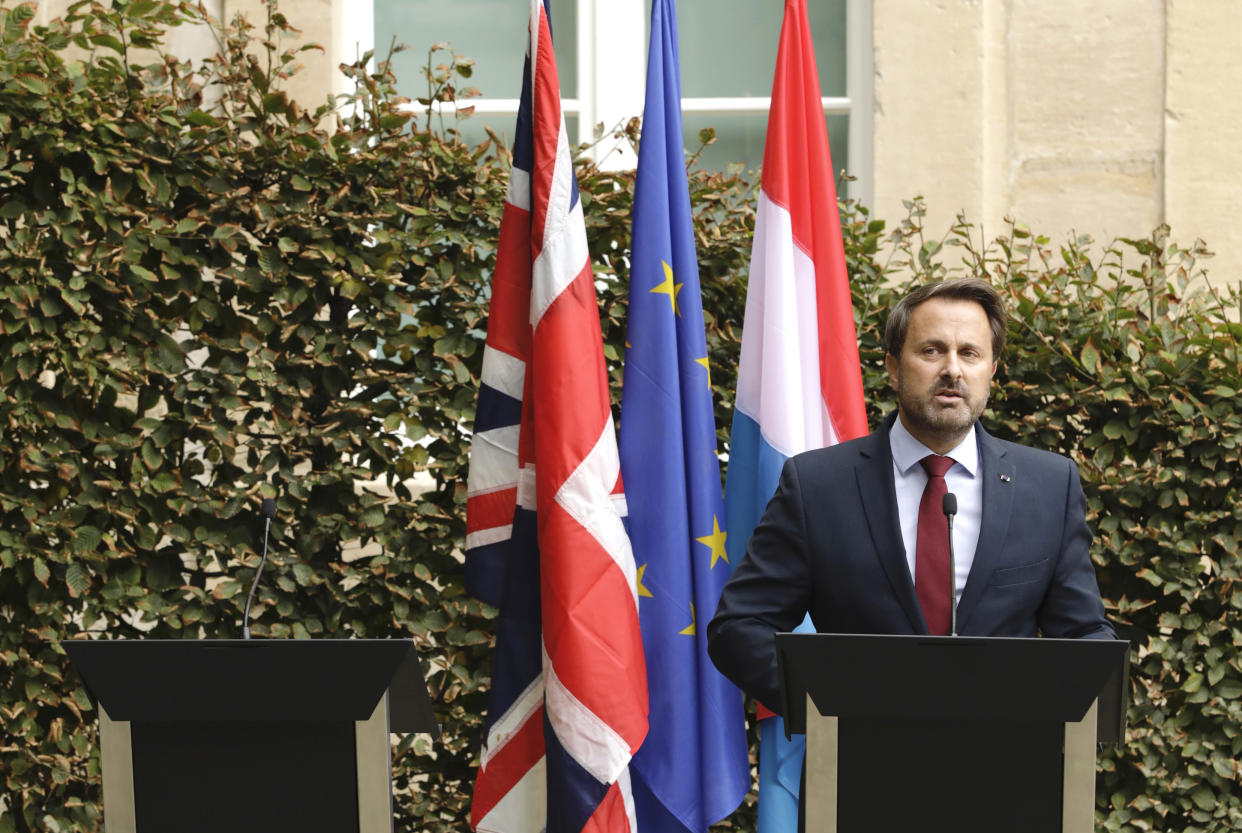 Luxembourg's Prime Minister Xavier Bettel, right, addresses a media conference next to an empty lectern intended for British Prime Minister Boris Johnson after a meeting at the prime ministers office in Luxembourg, Monday, Sept. 16, 2019. (AP Photo/Olivier Matthys)