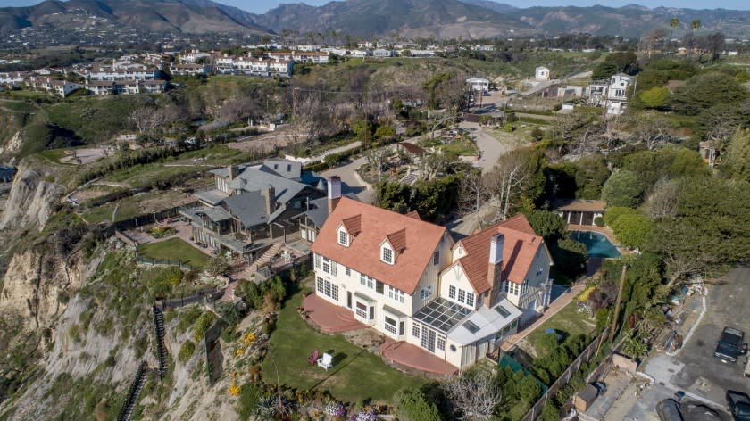 The coastal Cape Cod features Saltillo tile floors, picture windows and a solarium with glass ceilings.