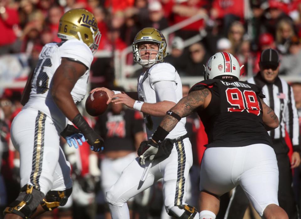 UCLA quarterback Josh Rosen drops back for a pass as Utah defensive tackle Viliseni Fauonuku goes in for a tackle