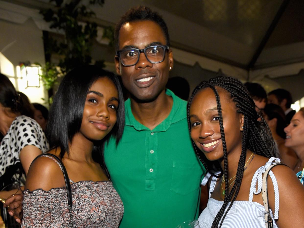 Chris Rock (center) with daughters Zahra Savannah Rock and Lola Simone Rock attend Apollo in the Hamptons 2017: hosted by Ronald O. Perelman at The Creeks on August 12, 2017 in East Hampton, New York