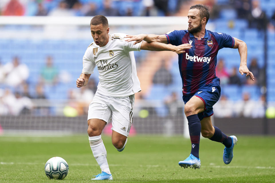 MADRID, SPAIN - SEPTEMBER 14: Eden Hazard of Real Madrid competes for the ball with Jorge Miramon of Levante UD during the La Liga match between Real Madrid CF and Levante UD at Estadio Santiago Bernabeu on September 14, 2019 in Madrid, Spain. (Photo by Quality Sport Images/Getty Images)