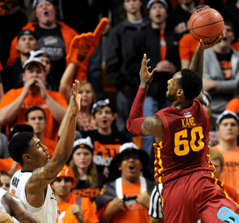 Iowa State guard DeAndre Kane, right, takes a shot over Oklahoma State Le'Bryan Nash, left, during an NCAA college basketball game in Stillwater, Okla., Monday, Feb. 3, 2014. Kane scored 26 points in the 98-97 triple overtime win over Oklahoma State. (AP Photo/Brody Schmidt)