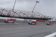 Crews try to dry the track after a rain shower before a NASCAR Cup Series auto race Sunday, Sept. 1, 2019, at Darlington Raceway in Darlington, S.C. (AP Photo/Richard Shiro)