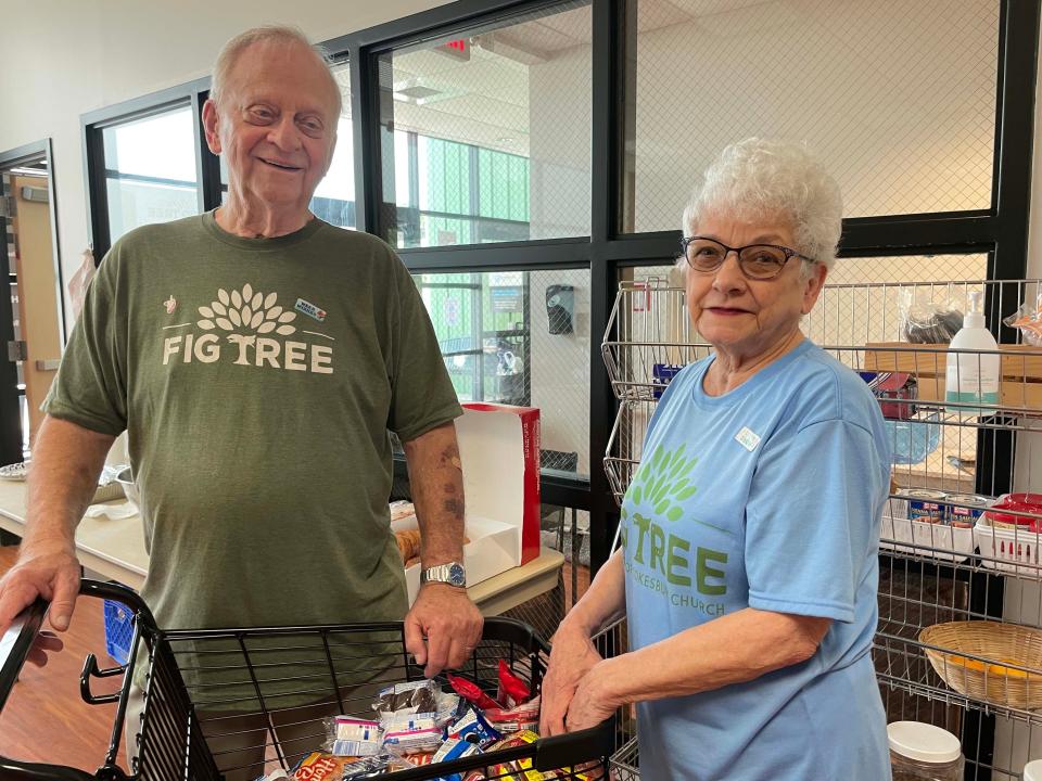 Volunteers Ron Coffee and Sue Coffee hand out to-go snacks at Fig Tree, a homeless community outreach program sponsored by Cokesbury United Methodist Church, on June 1, 2022.