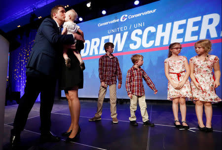 Andrew Scheer greets his family on stage after winning the leadership at the Conservative Party of Canada leadership convention in Toronto, Ontario, Canada, May 27, 2017. REUTERS/Mark Blinch