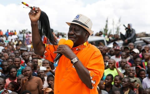 Raila Odinga addresses thousands of his supporters as he drives through Kawangware slum after attending a church service in Nairobi, Kenya - Credit: DANIEL IRUNGU/ EPA