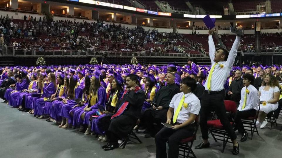 A students jumps in celebration during the Fresno High graduation ceremony held at the Save Mart Center on June 5, 2023.