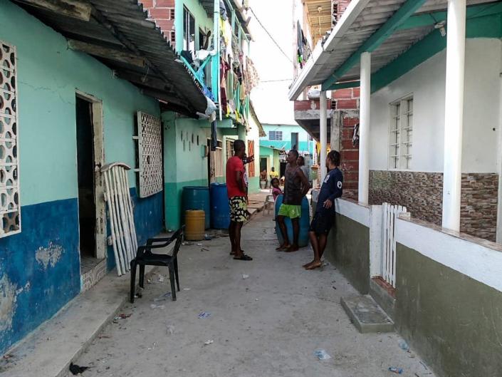 Locals walk in a street at Santa Cruz del Islote island, located in the Colombian Caribbean.