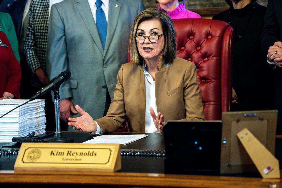 Gov. Kim Reynolds speaks during a bill signing ceremony to reorganize state government on Tuesday, April 4, 2023, at the Iowa State Capitol in Des Moines, Iowa.