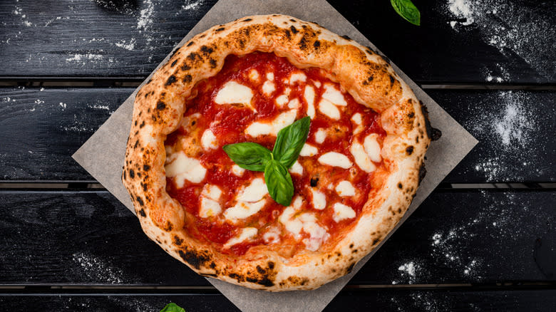 Homemade margherita pizza on black table