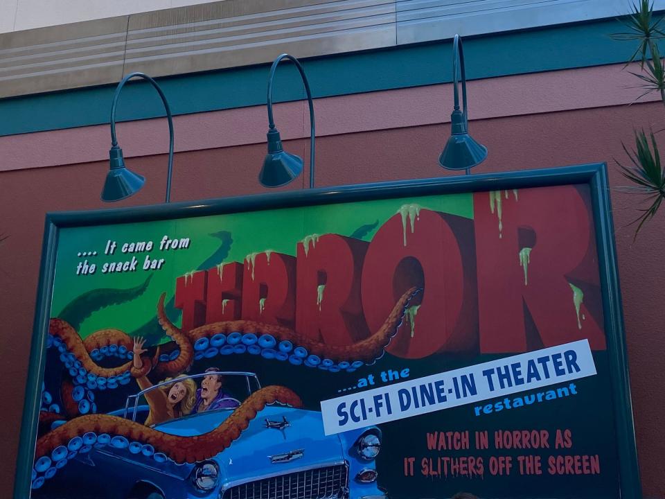 exterior shot of the billboard outside of sci-fin dine-in at disney world