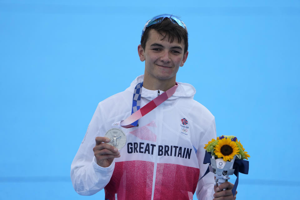 Alex Yee of Great Britain holds his silver medal during a medal ceremony for the men's individual triathlon at the 2020 Summer Olympics, Monday, July 26, 2021, in Tokyo, Japan. (AP Photo/Jae C. Hong)