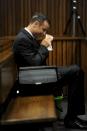 Olympic and Paralympic track star Oscar Pistorius sits in the dock during court proceedings at the North Gauteng High Court in Pretoria March 18, 2014. Pistorius is on trial for murdering his girlfriend Reeva Steenkamp at his suburban Pretoria home on Valentine's Day last year. REUTERS/Werner Beukes/Pool (SOUTH AFRICA - Tags: SPORT CRIME LAW ATHLETICS)