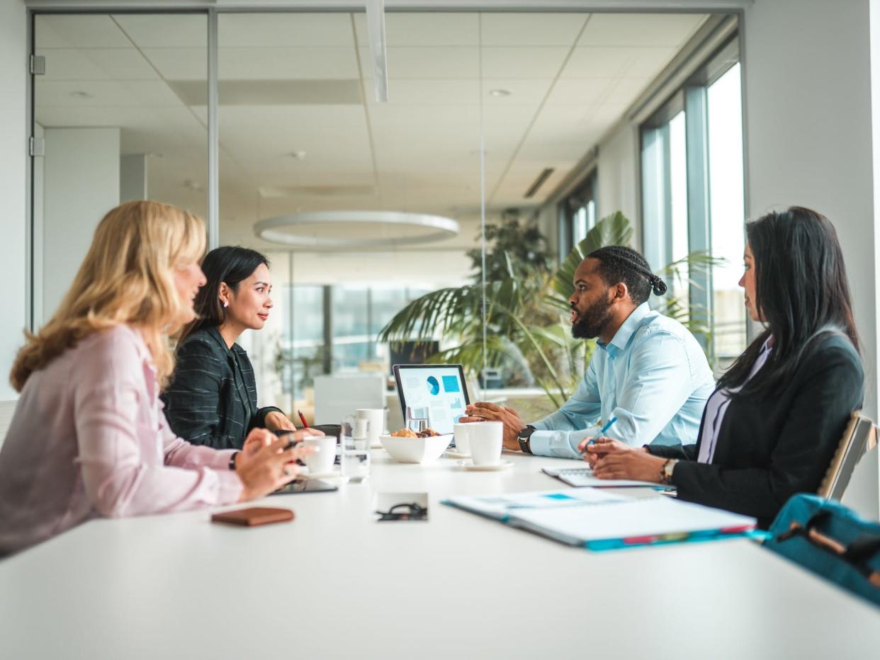 Four people in a meeting in an office