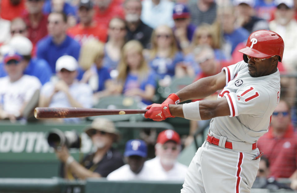 Philadelphia Phillies' Jimmy Rollins hits a grand slam home run against the Texas Rangers during the second inning of an opening day baseball game at Globe Life Park, Monday, March 31, 2014, in Arlington, Texas. (AP Photo/Kim Johnson Flodin)