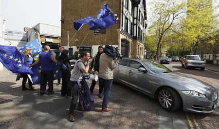 Pro-European Union demonstrators wave flags as Britain's Prime Minister Theresa May leaves ITV's studios, in London, April 30, 2017. REUTERS/Peter Nicholls