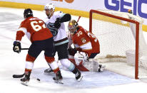 Seattle Kraken right wing Jordan Eberle (7) and Florida Panthers defenseman Brandon Montour (62) work for the puck in front of Panthers goaltender Spencer Knight (30) during the first period of an NHL hockey game Saturday, Nov. 27, 2021, in Sunrise, Fla. (AP Photo/Jim Rassol)