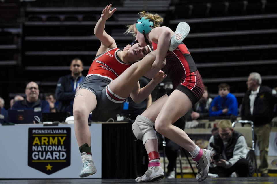 Easton's Aubre Krazer, right, takes down Hazleton Area's Miah Molinaro, left, during the first found of the PIAA High School Wrestling Championships in Hershey, Pa., Thursday, March 7, 2024. Girls’ wrestling has become the fastest-growing high school sport in the country. (AP Photo/Matt Rourke)