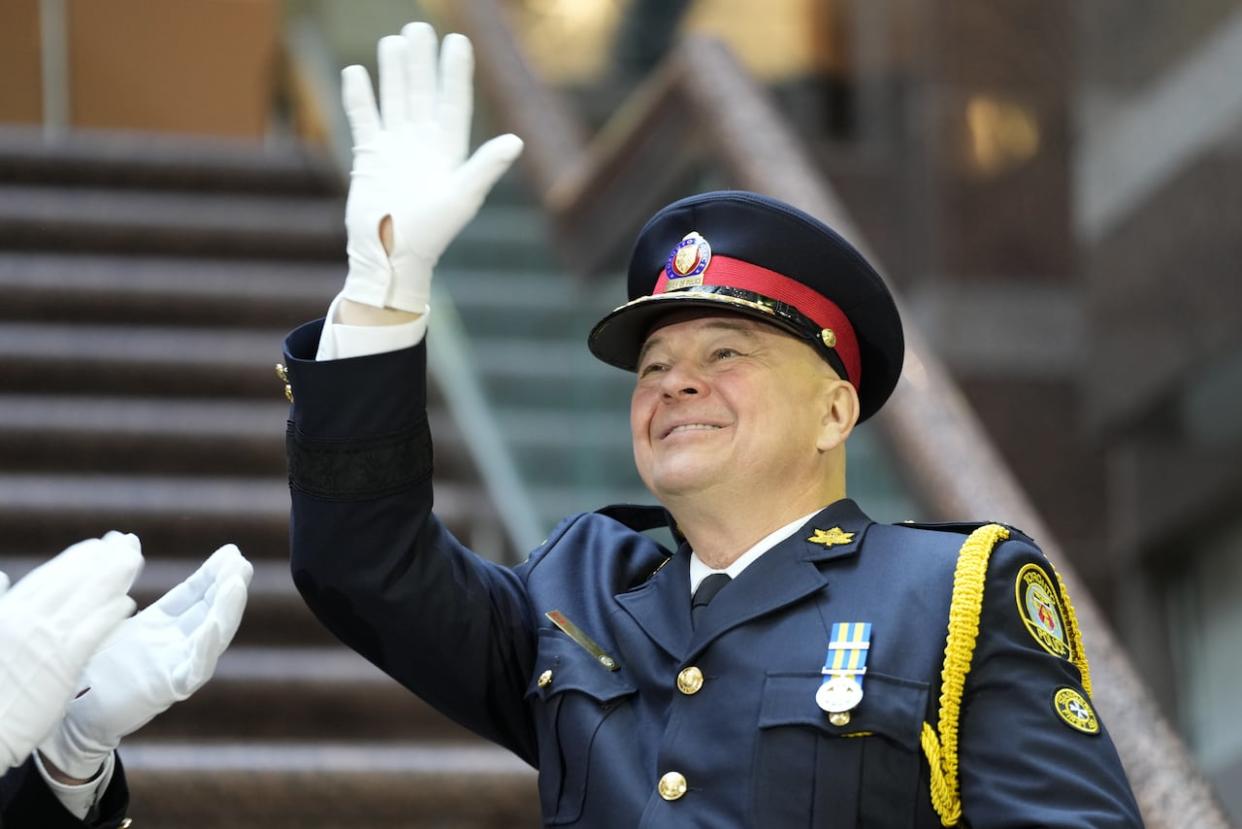 Toronto Police Chief Myron Demkiw waves after taking the oath of office during a police change of command ceremony in Toronto, Monday, Dec.19, 2022. Demkiw is calling a city staff proposal to increase the police budget by $7.4 million this year, and not the $20 million it has asked for, a cut.  (Frank Gunn/The Canadian Press - image credit)