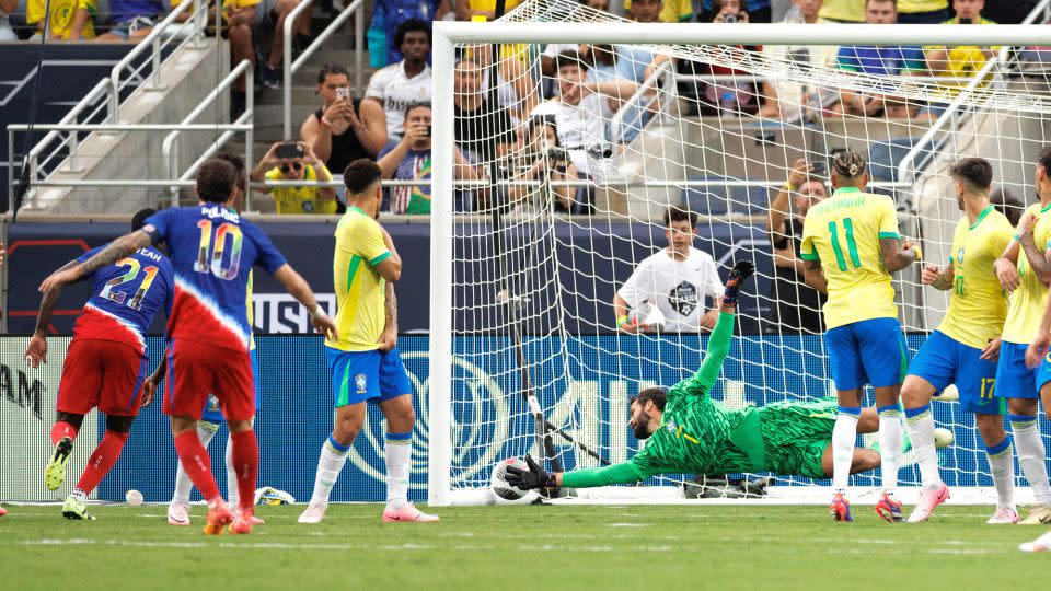 Pulisic scores a goal past Brazil goalkeeper Alisson. - Nathan Ray Seebeck/USA TODAY Sports/Reuters