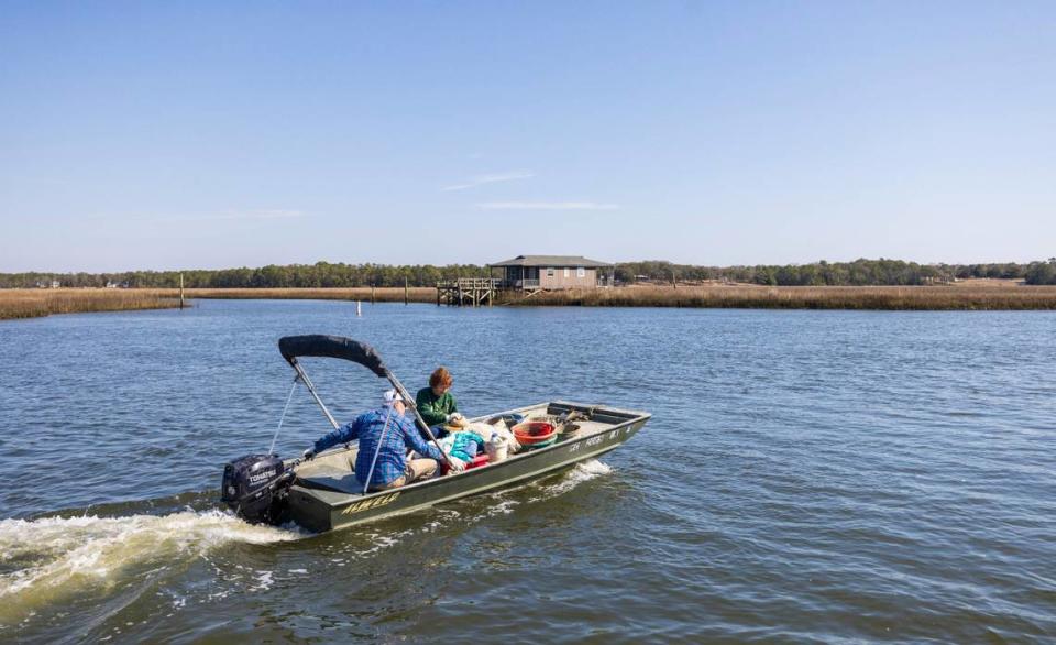 Ernie Galloway and his wife Barbara Galloway launch their boat into the Lockwood Folly River to harvest oysters on Thursday, February 22, 2024 in Varnamtown, N.C.