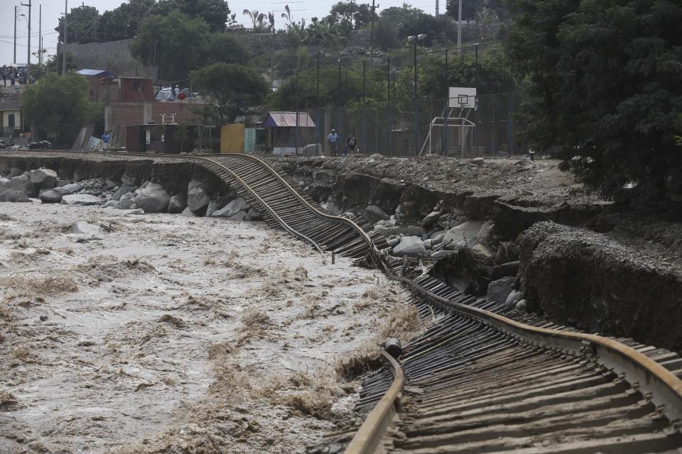 Train tracks lay destroyed in a flooded river in the Chosica district of Lima, Peru, Sunday, March 19, 2017. Intense rains and mudslides over the past three days have wrought havoc around the Andean nation and caught residents in Lima, a desert city of 10 million where it almost never rains, by surprise. (AP Photo/Martin Mejia)