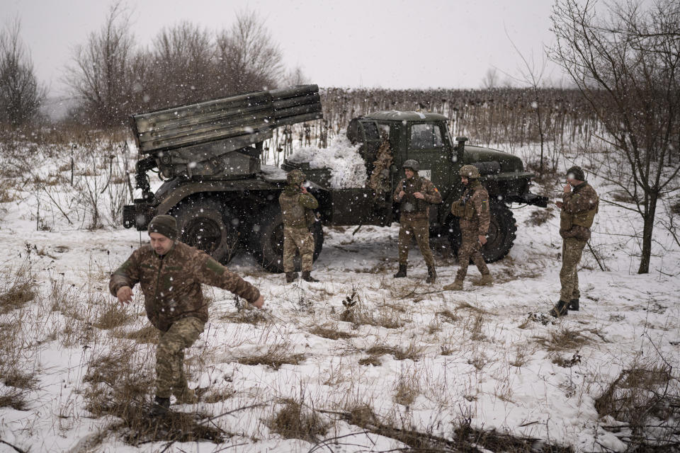 FILE - Ukrainian servicemen of the Prince Roman the Great 14th Separate Mechanized Brigade stand around a Soviet era Grad multiple rocket launcher before firing at Russian positions in the Kharkiv area, Ukraine, Saturday, Feb. 25, 2023. Grueling artillery battles have stepped up in recent weeks in the vicinity of Kupiansk, a strategic town on the eastern edge of Kharkiv province by the banks of the Oskil River as Russian attacks intensifying in a push to capture the entire industrial heartland known as the Donbas, which includes the Donetsk and the Luhansk provinces. (AP Photo/Vadim Ghirda, File)