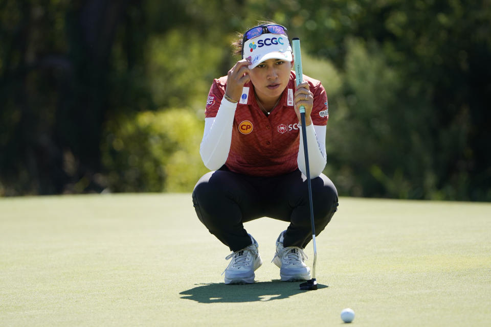 FILE - Thailand's Atthaya Thitikul lines up a putt on the eighth green during the LPGA The Ascendant golf tournament in The Colony, Texas, Oct. 1, 2022. Atthaya shot a 9-under 63 to set a tournament record and lead after the first round of the BMW Ladies Championship on Thursday, Oct. 20, in Wonju, South Korea. (AP Photo/LM Otero, File)