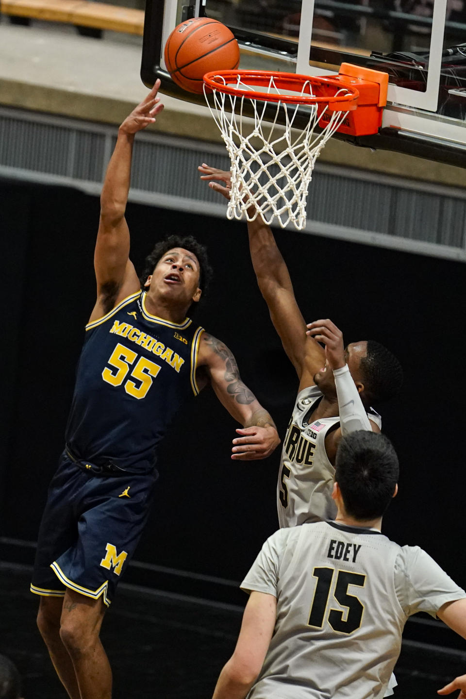 Michigan guard Eli Brooks (55) shoots in front of Purdue guard Brandon Newman (5) during the second half of an NCAA college basketball game in West Lafayette, Ind., Friday, Jan. 22, 2021. (AP Photo/Michael Conroy)